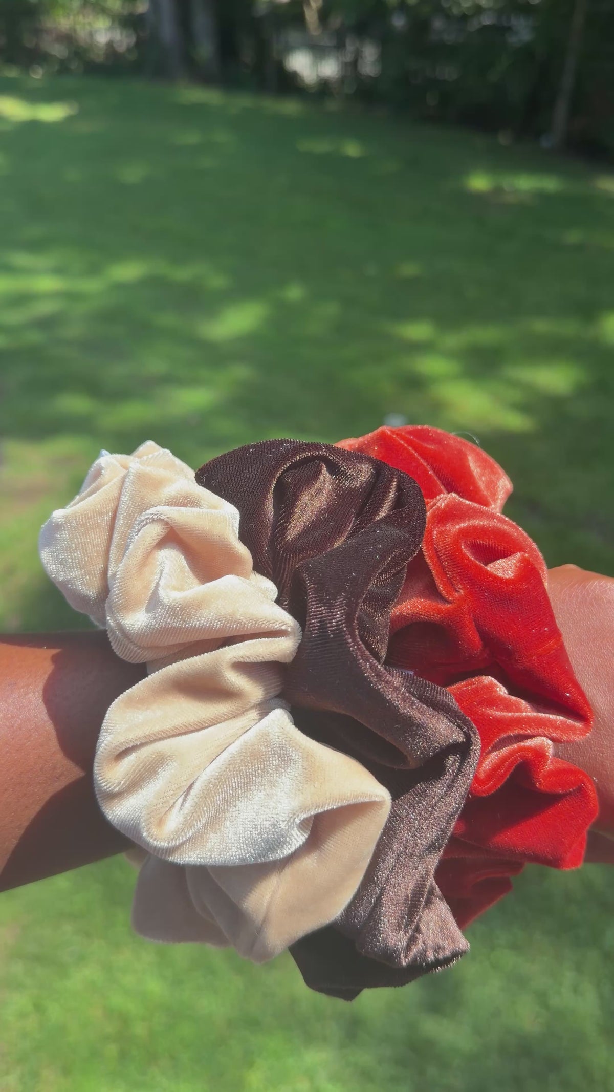 Load video: There are 3 extra large scrunchies on a hand being turned around to showcase the  texture and quality of the scrunchies.